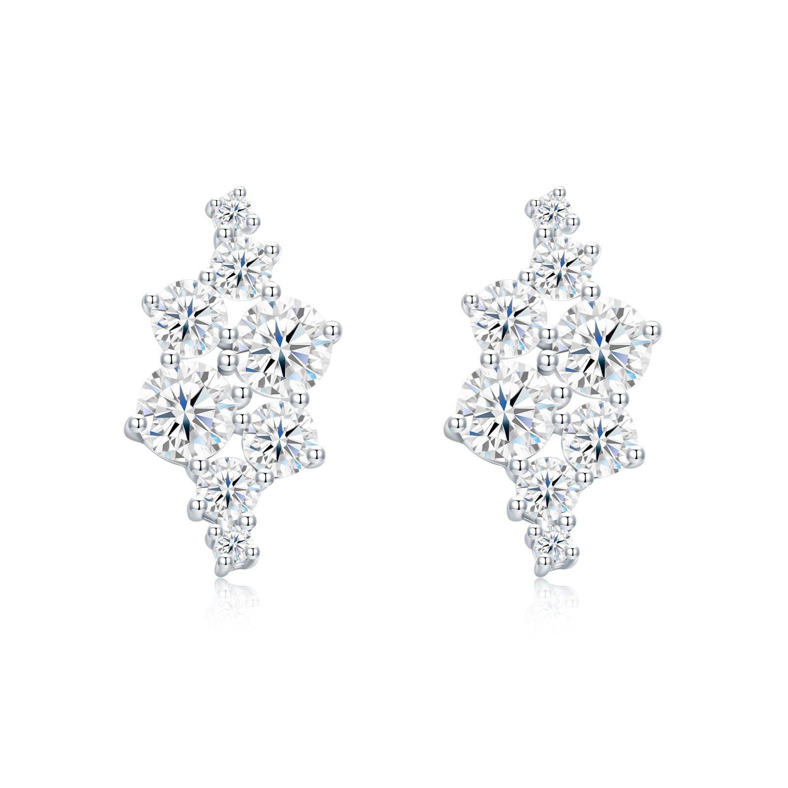 Asymmetric cluster moissanite stud earrings in sterling silver on white background.