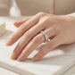 Close-up view of model showing smooth channel set moissanite eternity band on hand.