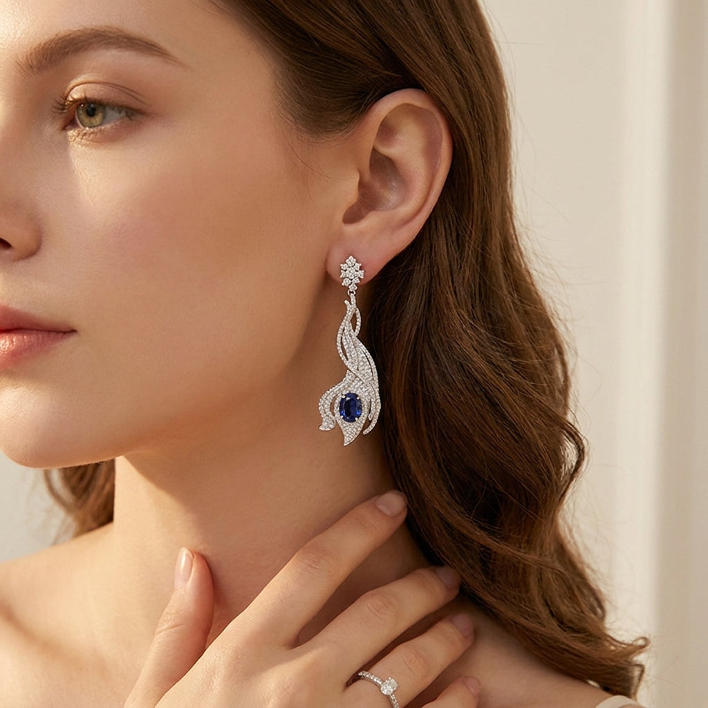 Model wearing 5ct royal blue sapphire wave earrings, front view, high fashion look.