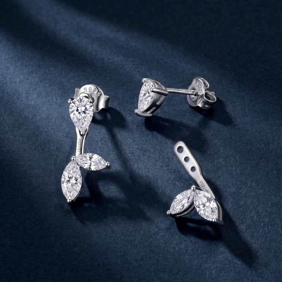 Pear cut studs and removable marquise leaf ear jackets displayed on dark background.