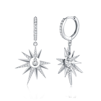Celestial moissanite starburst crescent moon dangle hoop earrings with pave huggie on white background.