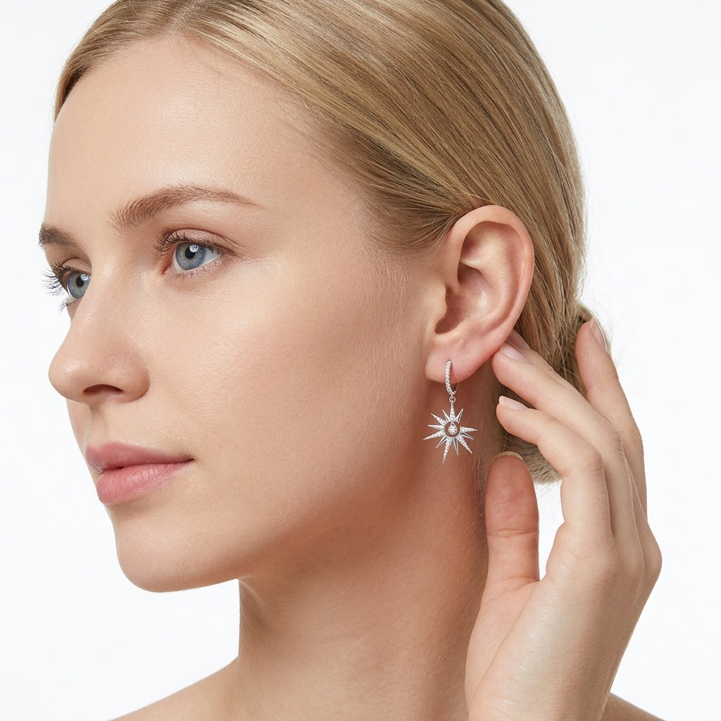 Model showing celestial moissanite starburst crescent moon dangle hoop earrings on ear.