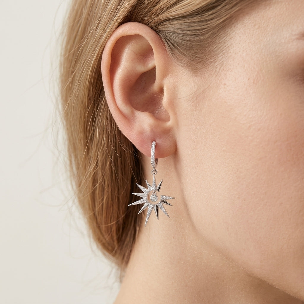 Front view showing matching celestial starburst crescent moon moissanite dangle hoop earrings.