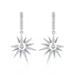 Close-up view of a model wearing celestial starburst crescent moon moissanite dangle hoop earring.