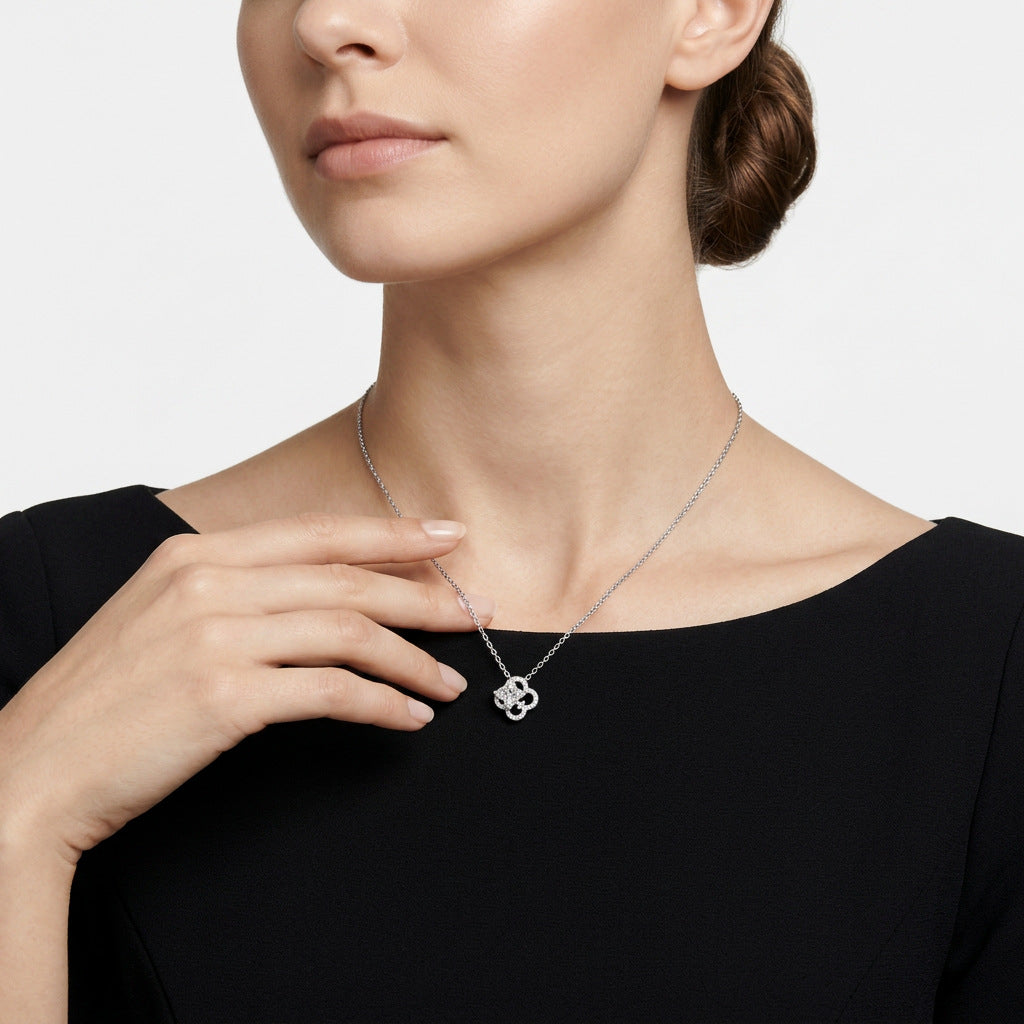 Model wearing celestial star cut moissanite openwork clover pendant necklace.