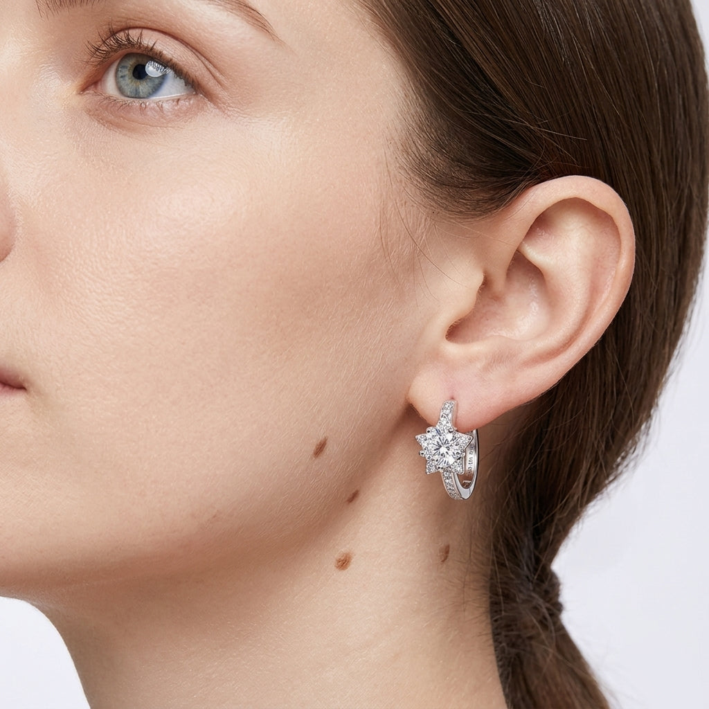 Model close-up profile wearing star halo diamond huggie hoop earrings.