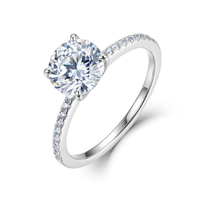 Classic 4-prong round cut lab grown diamond engagement ring with pavé band in sterling silver isolated on white background