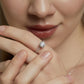 Model wearing classic 4-prong round cut lab grown diamond solitaire engagement ring on finger