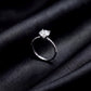 Side profile view showing 4-prong setting and pavé band of lab grown diamond ring on black silk