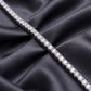 Straight profile view of classic 4-prong round lab-grown diamond tennis bracelet on dark silk.