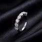 Side profile view showing shared prong setting of 7 stone round lab grown diamond ring on black silk