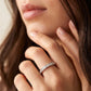 Woman wearing classic channel set lab grown diamond band ring on finger