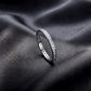 Side profile view of channel set lab grown diamond eternity ring standing on dark silk