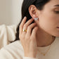 High-end fashion lookbook view of a model showcasing classic coquette balletcore moissanite ribbon bow earrings near her chin.
