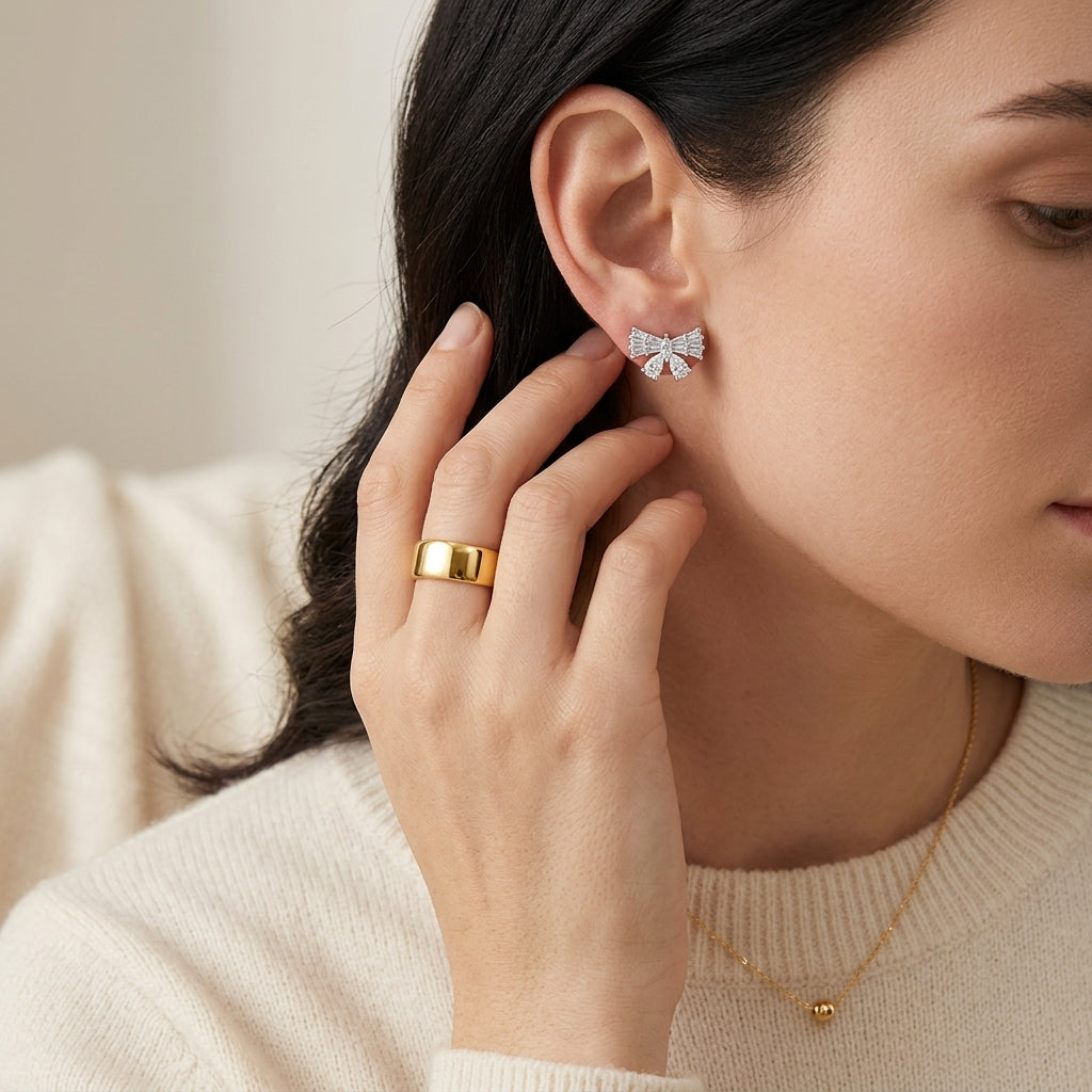 High-end fashion lookbook view of a model showcasing classic coquette balletcore moissanite ribbon bow earrings near her chin.