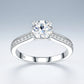 Symmetrical frontal studio view of a classic d vvs1 moissanite solitaire ring highlighting the elegant architectural arch and pave shank.