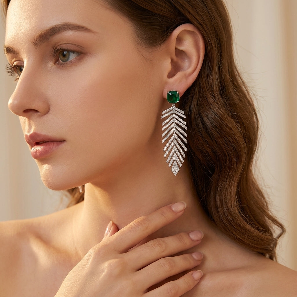 Close-up of a model wearing the princess-cut emerald wheat fringe earrings showcasing the elegant earlobe placement.