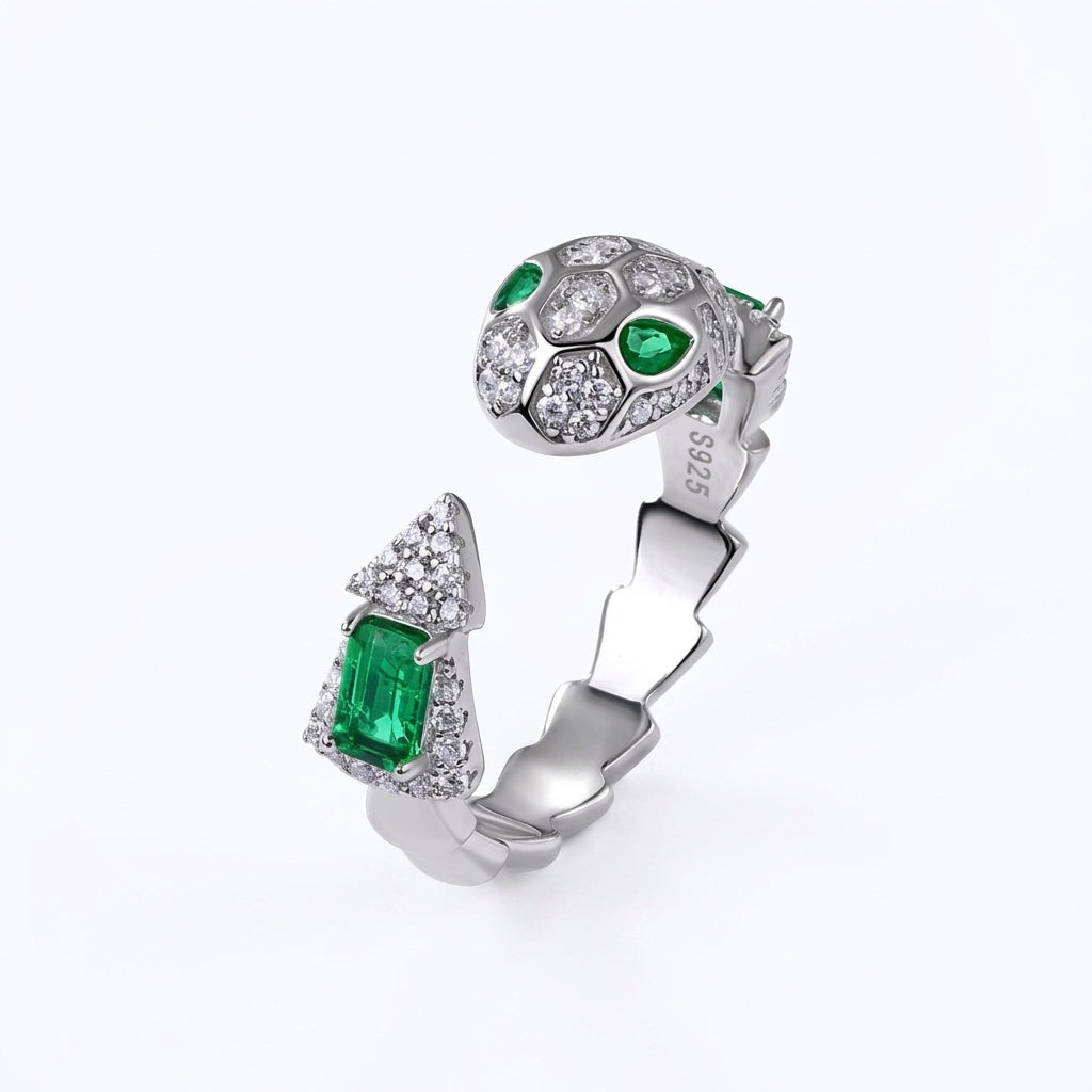 White background profile view of a classic emerald-cut snake wrap-around ring with a textured scaly open band.