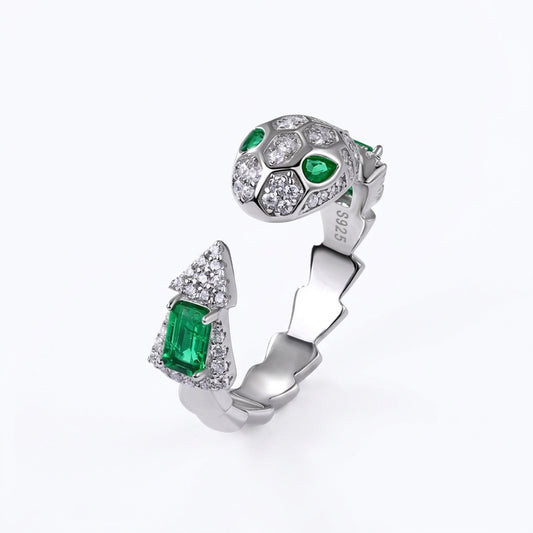 White background profile view of a classic emerald-cut snake wrap-around ring with a textured scaly open band.