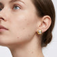 High-end fashion lookbook view of a model wearing classic gold chunky cushion square moissanite stud earrings.