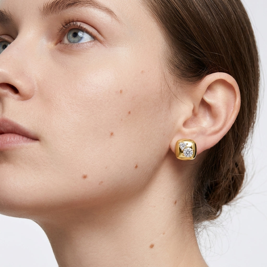 High-end fashion lookbook view of a model wearing classic gold chunky cushion square moissanite stud earrings.