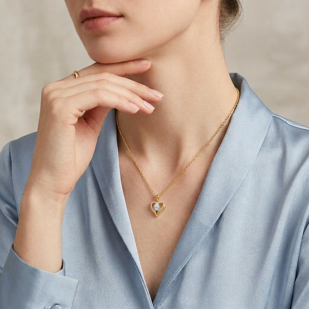 Classic gold pear moissanite open heart necklace worn by model with blue shirt, elegant style