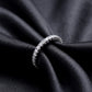 Close up side view of lab grown diamond eternity band ring on black silk