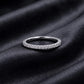 Classic lab grown diamond eternity wedding band resting flat on dark black silk fabric