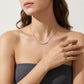Model showing classic shared prong moissanite curved smile necklace for everyday fine jewelry style.