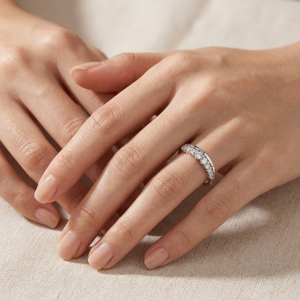 Elegant lifestyle wear shot of a model styling a classic old money graduated chevron wedding band on her ring finger.