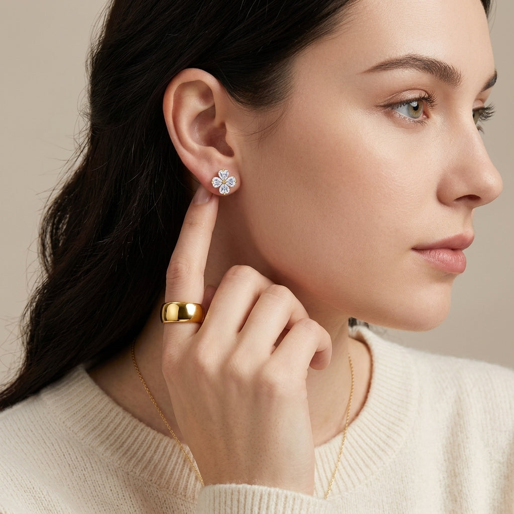 High-end fashion lookbook view of a model wearing classic romantic gold heart moissanite four-leaf clover stud earrings.