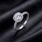 Side angle view of round cut cushion halo lab grown diamond engagement ring with pavé band on black silk