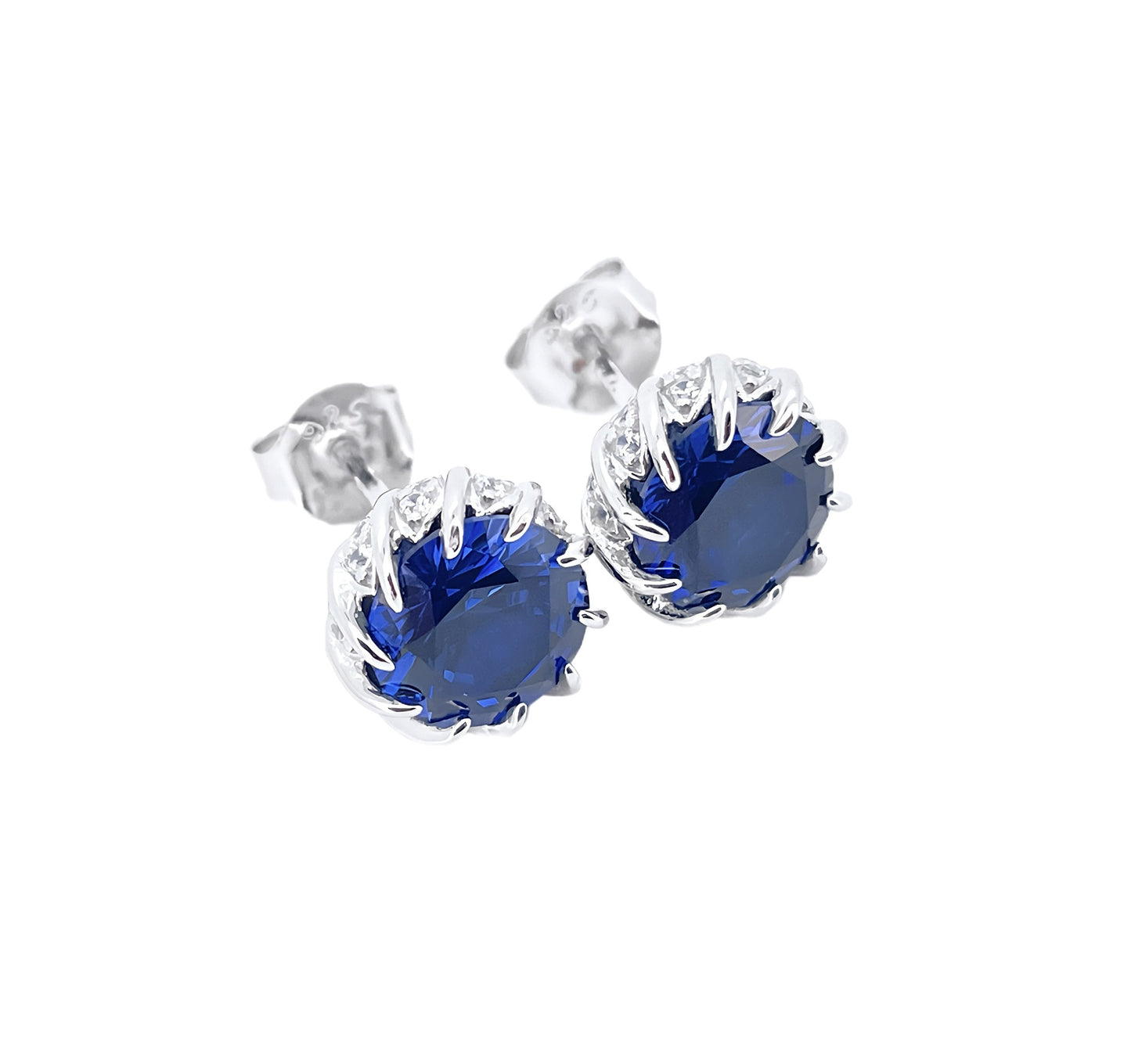 Silver earrings with blue gemstones on a white background