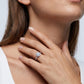 Woman wearing classic round cut cushion halo lab grown diamond engagement ring on finger