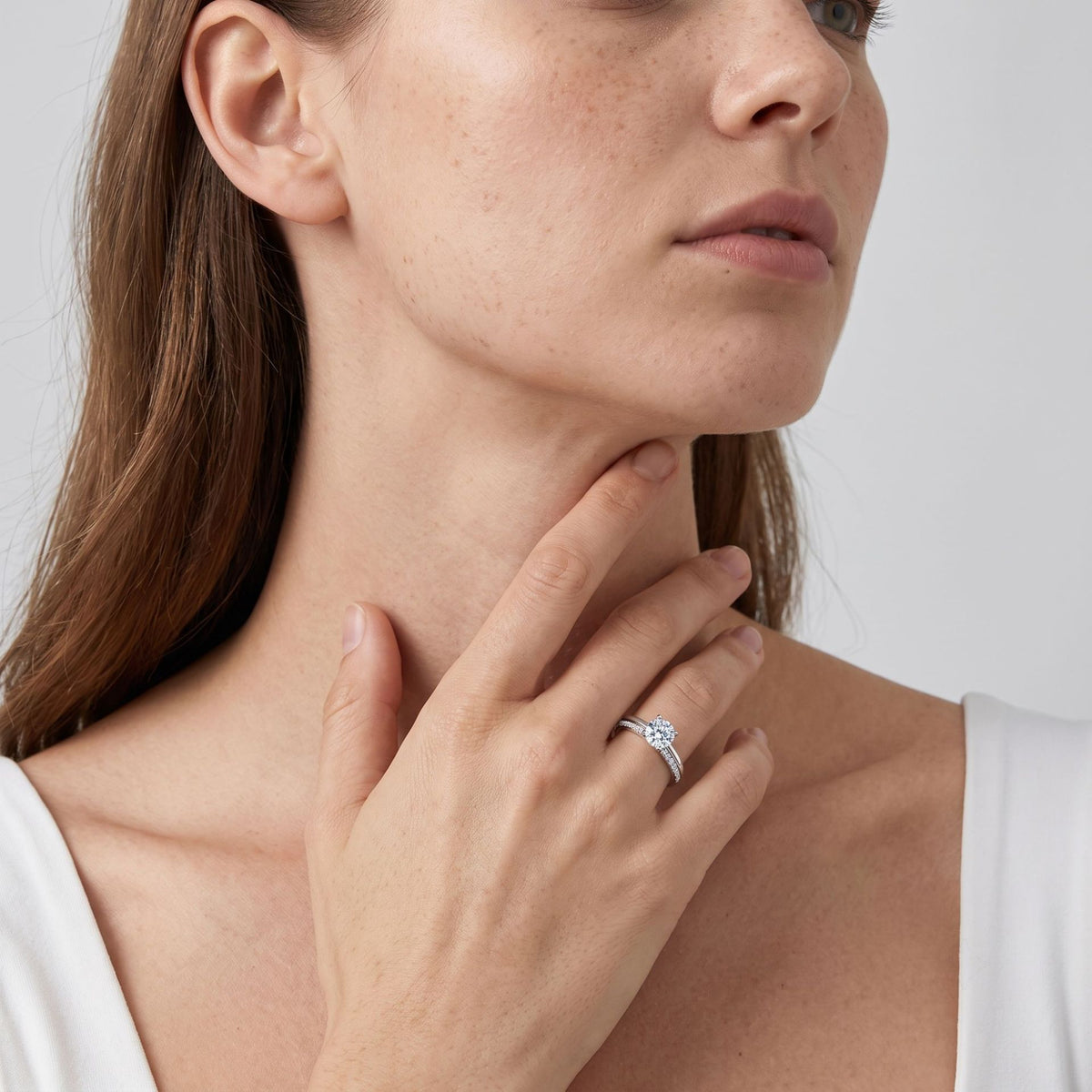 Woman wearing classic round cut lab grown diamond bridal stacking ring set on finger