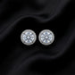 Frontal top view of pair of round halo lab grown diamond stud earrings on dark black silk