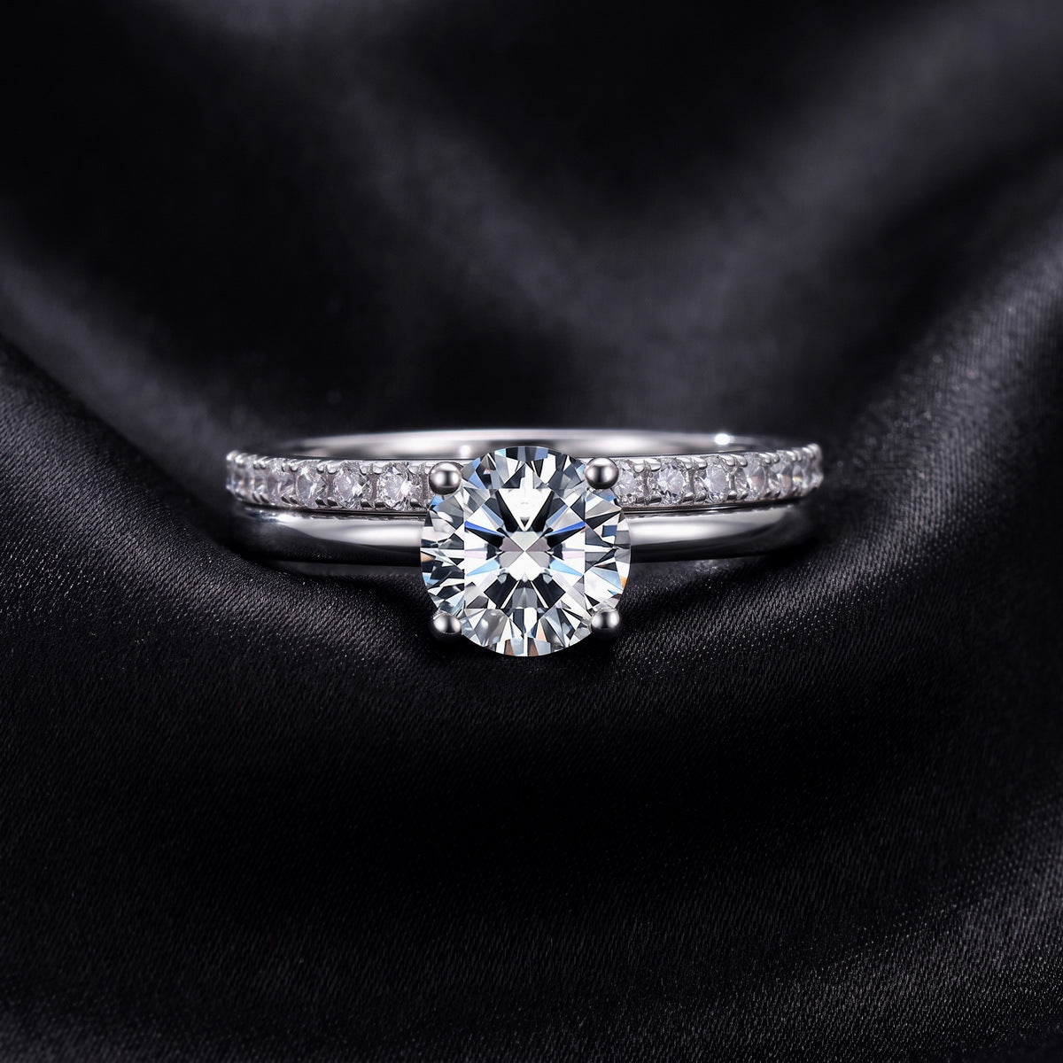 Front view of round brilliant lab grown diamond solitaire ring paired with pavé band on black silk