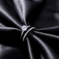 Close up top view of round lab grown diamond engagement ring and matching pavé wedding band
