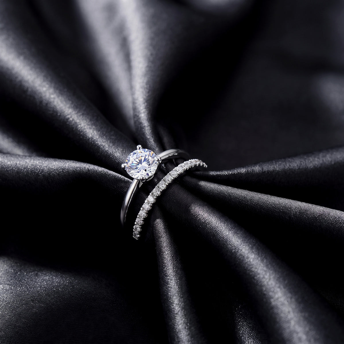 Close up top view of round lab grown diamond engagement ring and matching pavé wedding band