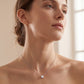 Model wearing classic four-prong round lab grown diamond solitaire necklace.
