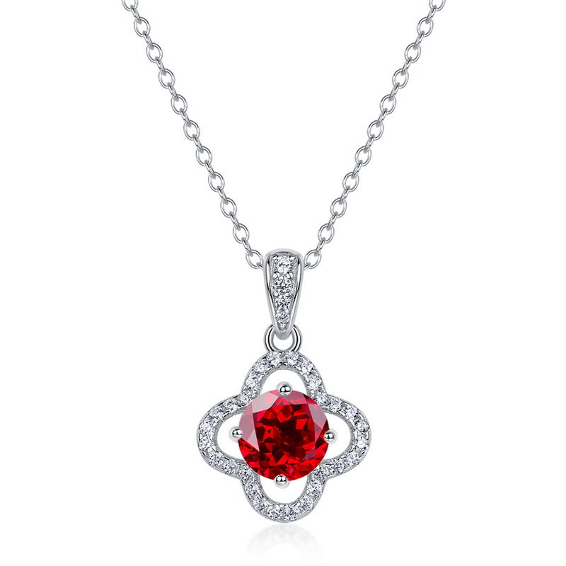 White background front view of a classic lab-grown ruby lucky clover talisman pendant on a silver chain.