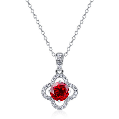 White background front view of a classic lab-grown ruby lucky clover talisman pendant on a silver chain.