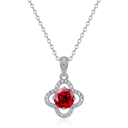 White background front view of a classic lab-grown ruby lucky clover talisman pendant on a silver chain.