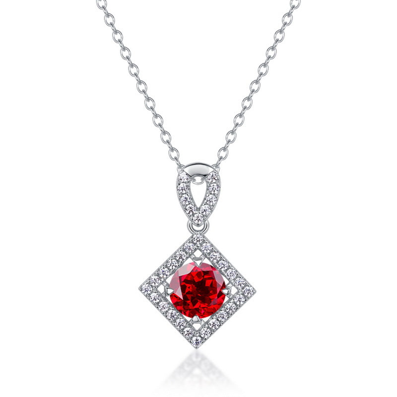 White background front view of a classic lab-grown ruby rhombus halo talisman pendant on a sterling silver chain.