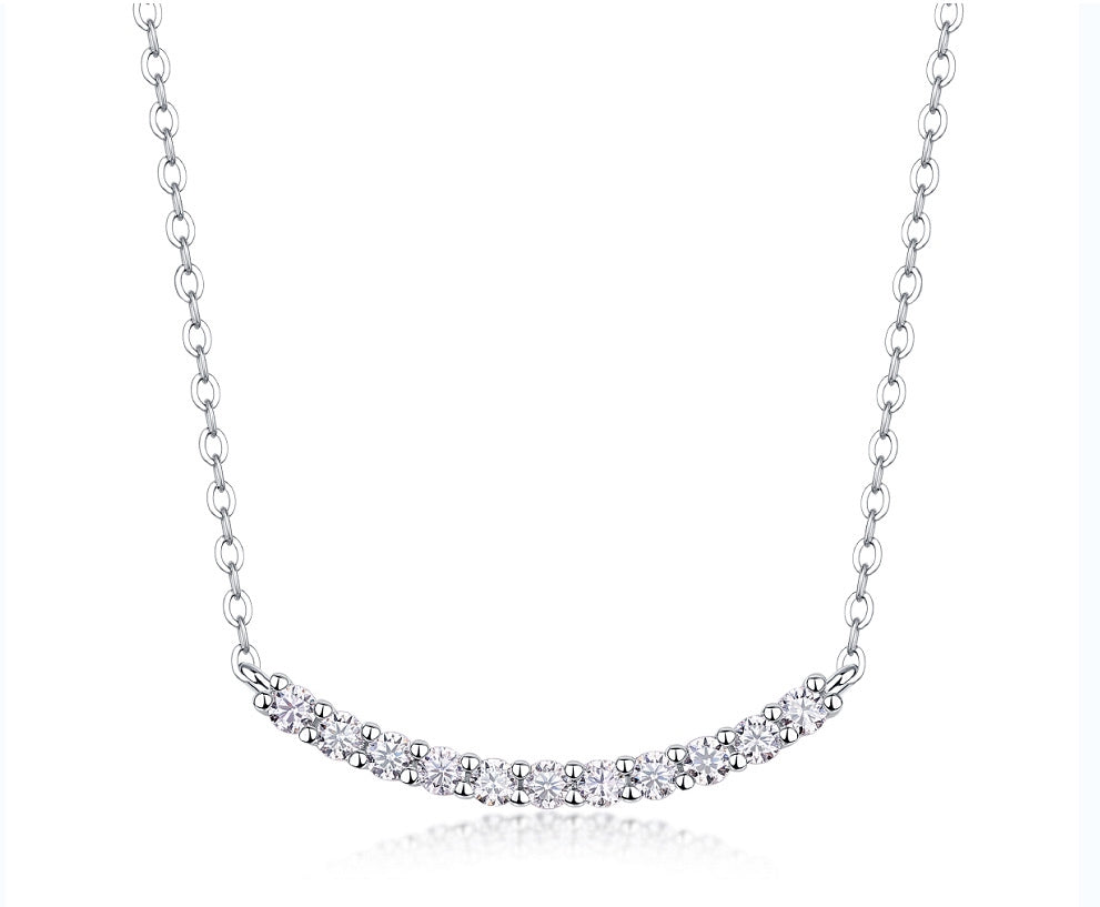Classic shared prong moissanite curved smile bar necklace in 925 sterling silver.