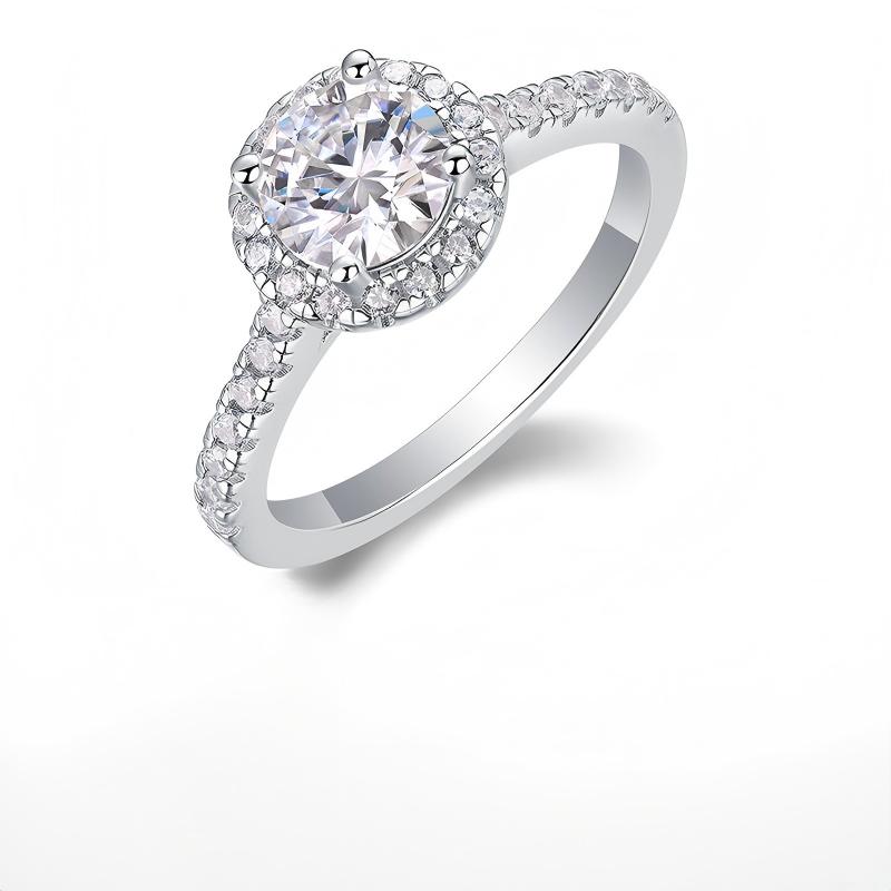 Classic silver 1 carat round cut moissanite halo engagement ring with pave band on white background.