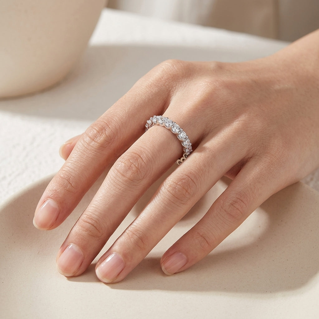 High-end fashion lookbook view of a model gracefully wearing a moissanite bubble half eternity stacking ring on hand.