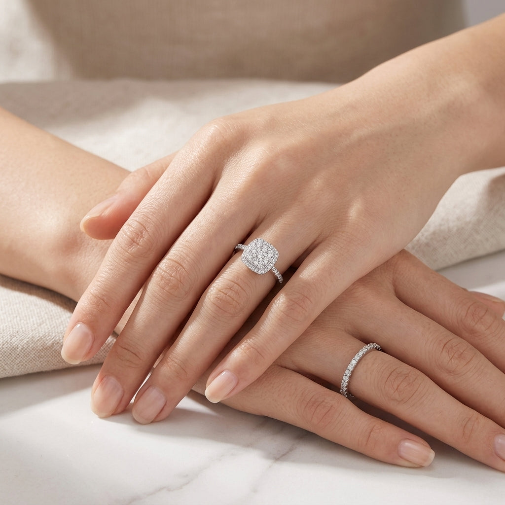 High-end fashion lookbook view of a model elegantly pairing a sugar cube halo cluster moissanite ring with a eternity band.
