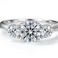 Extreme close-up shot of classic three-stone diamond accent past present future ring.