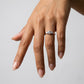 Full hand view of model wearing three-stone past present future engagement ring.